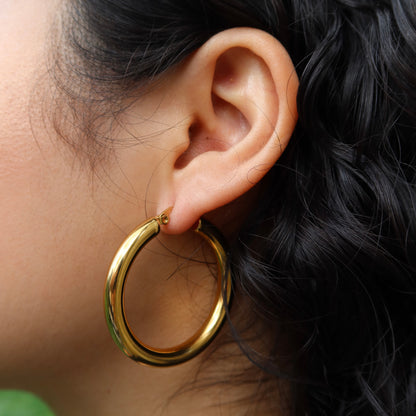 woman wearing Gold plated hoop earrings Hoop earrings from ShopEternidad.com Affordable 18K Gold Plated Jewelry